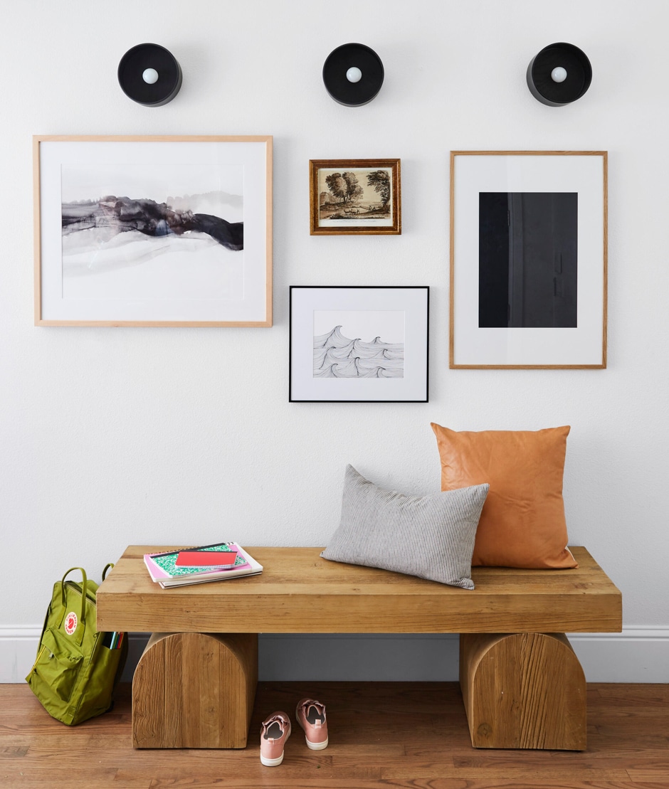 modern bench with gallery wall above
