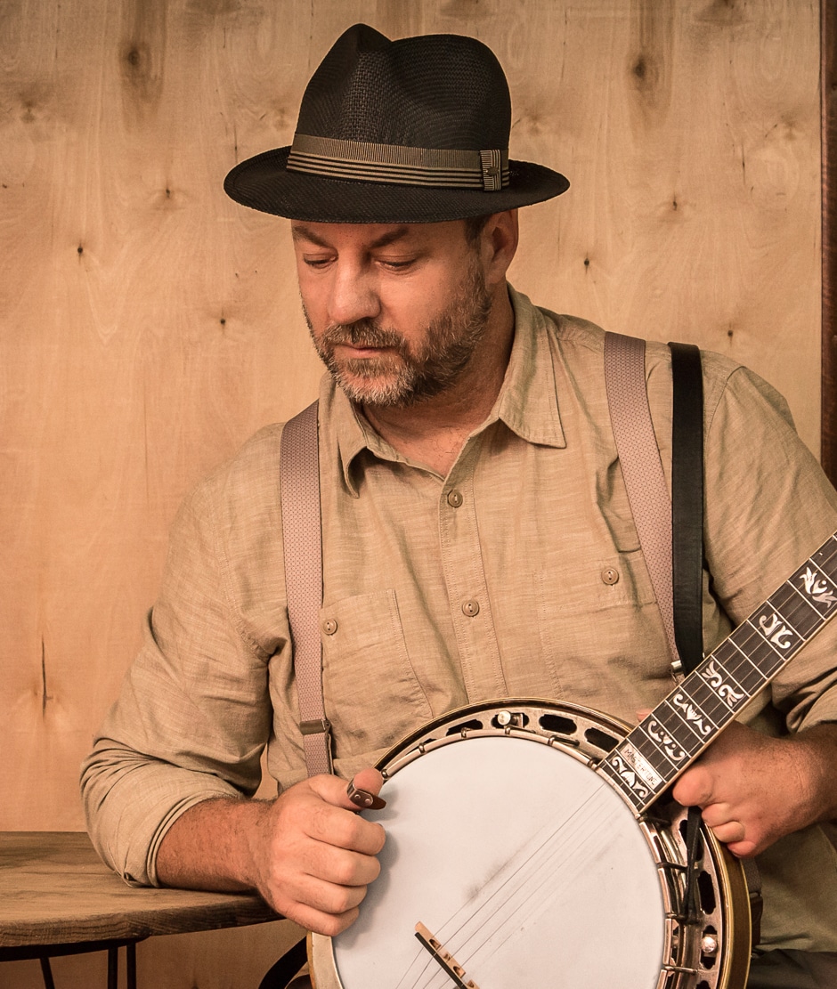 Barry holding banjo for portrait