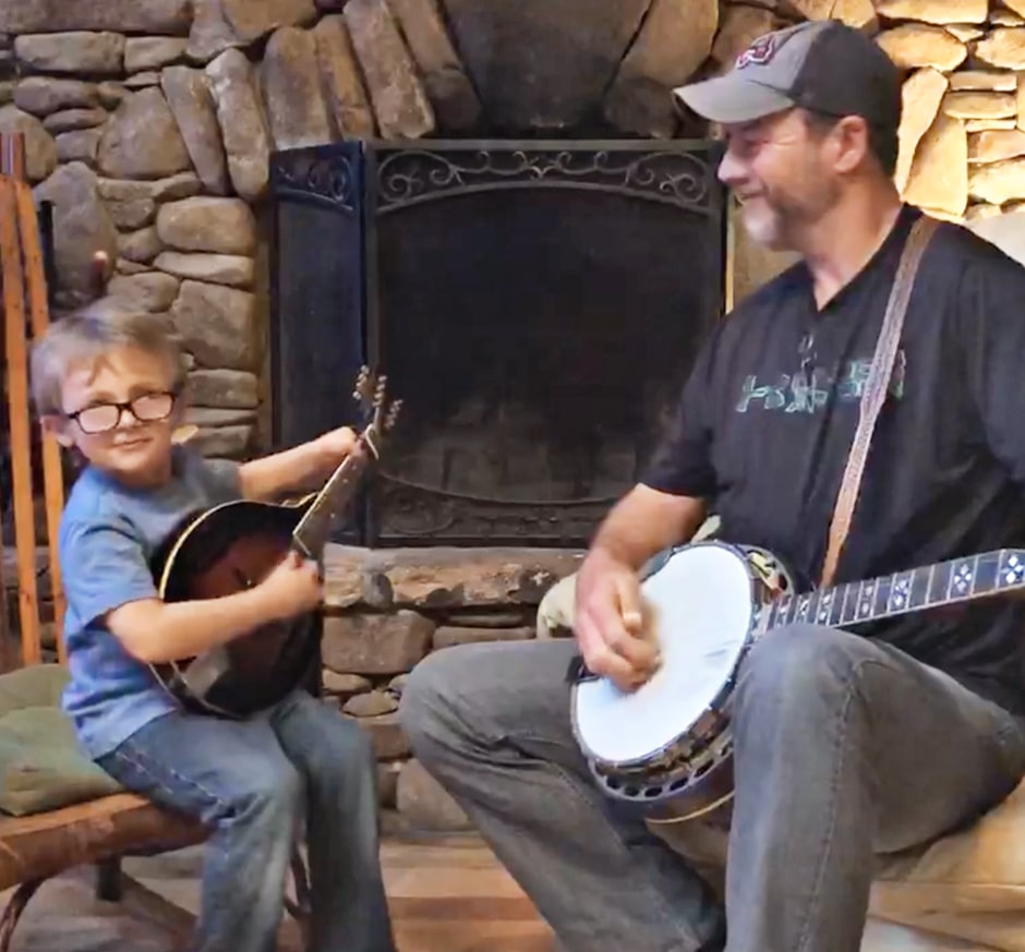 Tyler and Barry playing banjo in living room