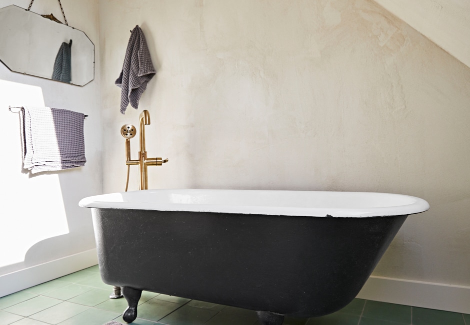 black claw foot bathtub in earth tones bathroom