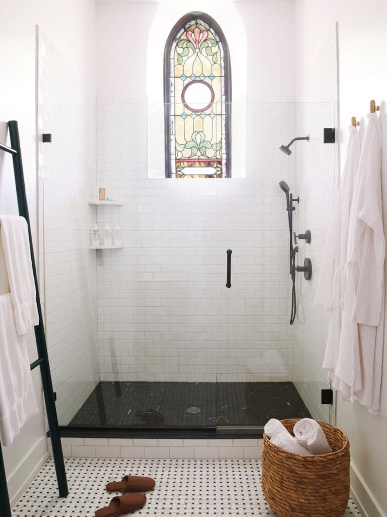 black and white shower with stained glass window
