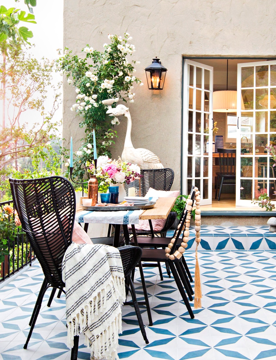 blue and white tiled patio with french doors and greenery and flowers