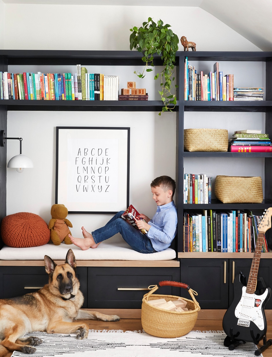 boy sitting on bench in reading nook