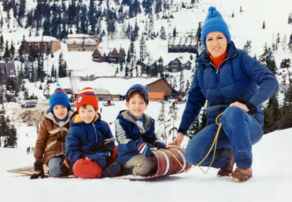 mom with three boys on sled