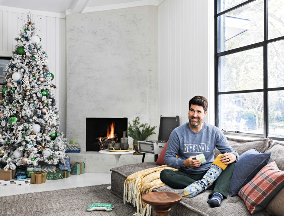 Brian sitting on couch in festively decorated living room