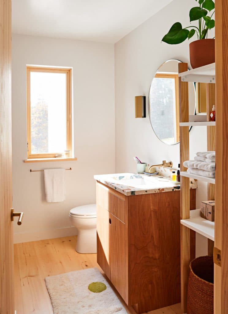 naturally lit bathroom with wooden floors, doors, and vanity