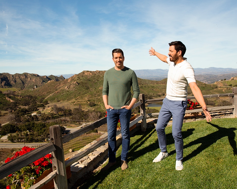 brothers standing on hill overlooking california mountains