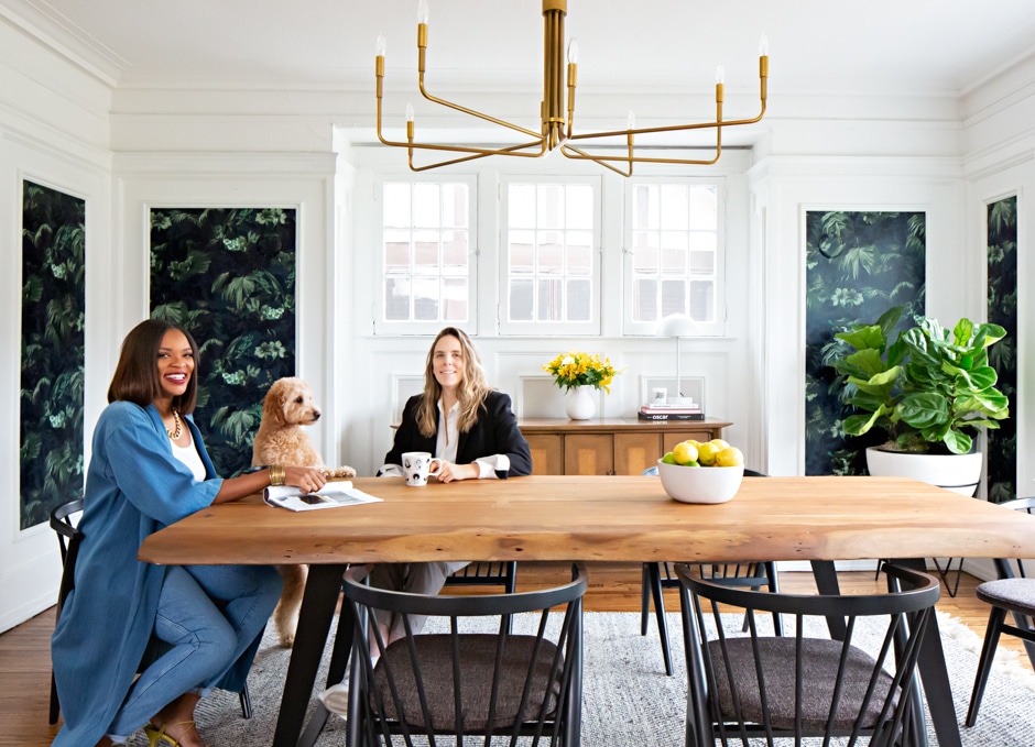 Candace and Pippa sitting in bright dining room with wallpapered columns