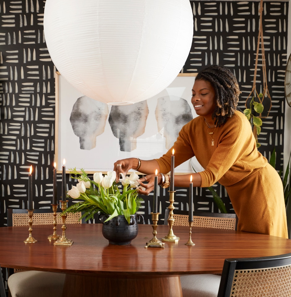 carmeon placing flowers on dining table