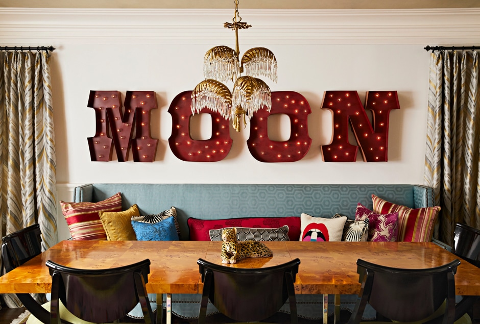 moon marquee letters sign above dining table and couch