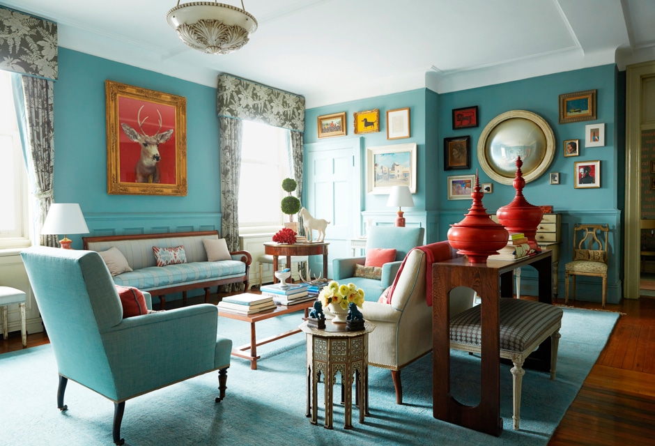 elegant green-blue and red sitting room with antiques