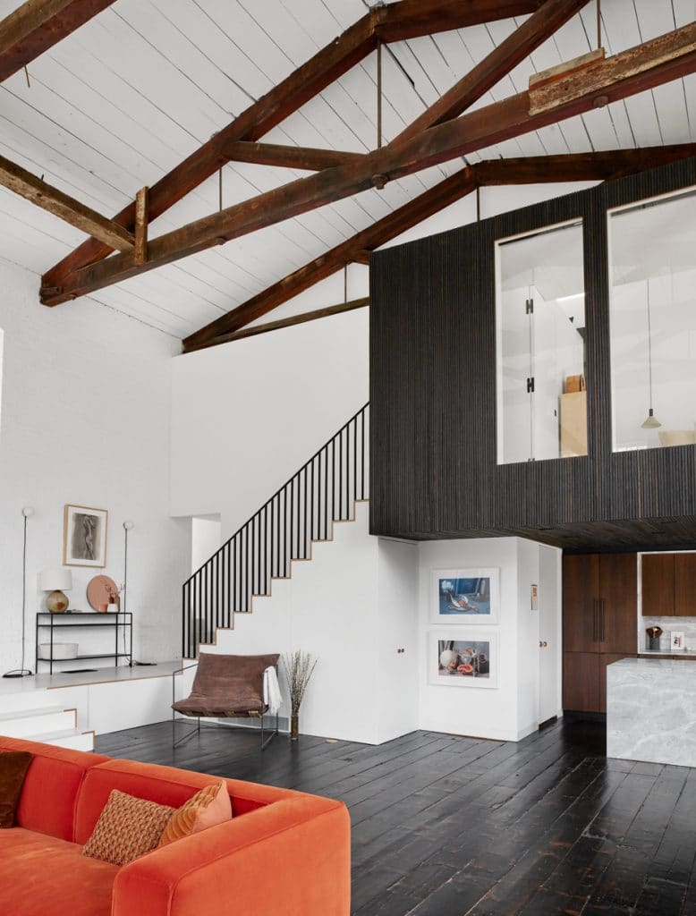 high ceiling industrial space with exposed dark wooden rafters