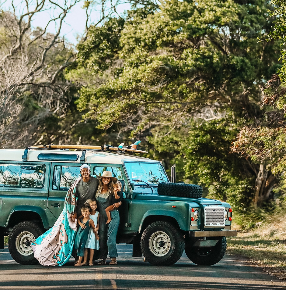 family portrait in front of SUV