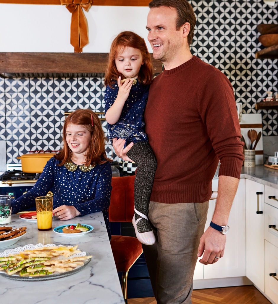 father and daughters in kitchen