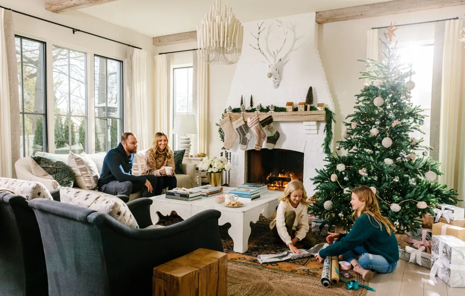 family wrapping presents in festive living room