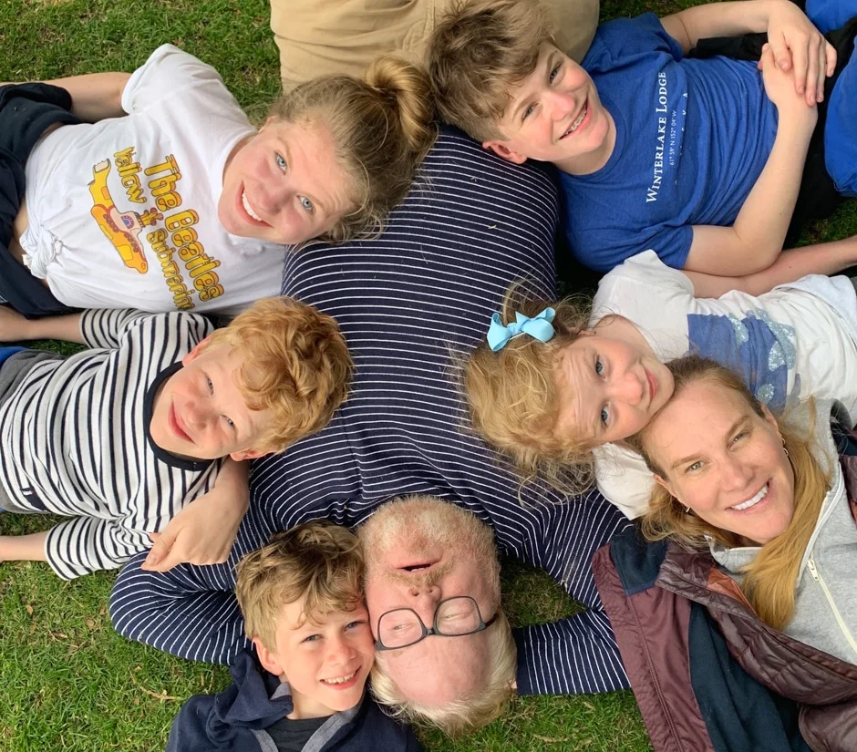 Gaffigan family lying on grass together