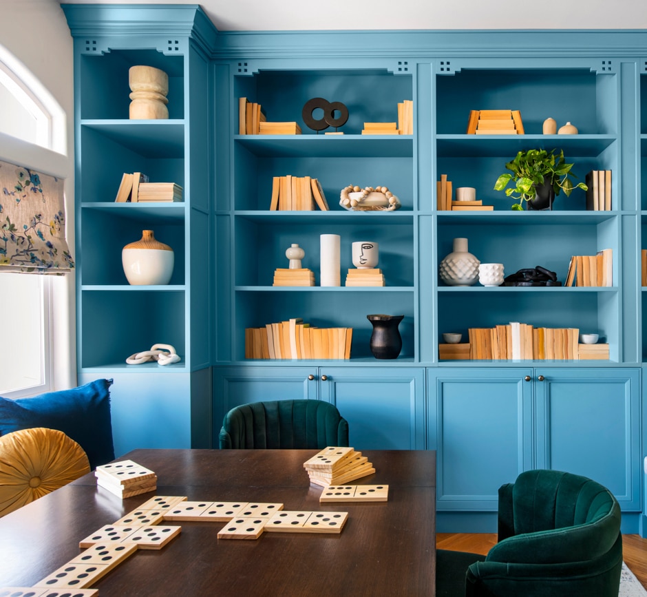 blue cabinet wall game room with wooden table and giant dominos