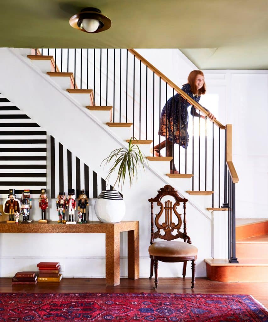 girl running down elegant staircase