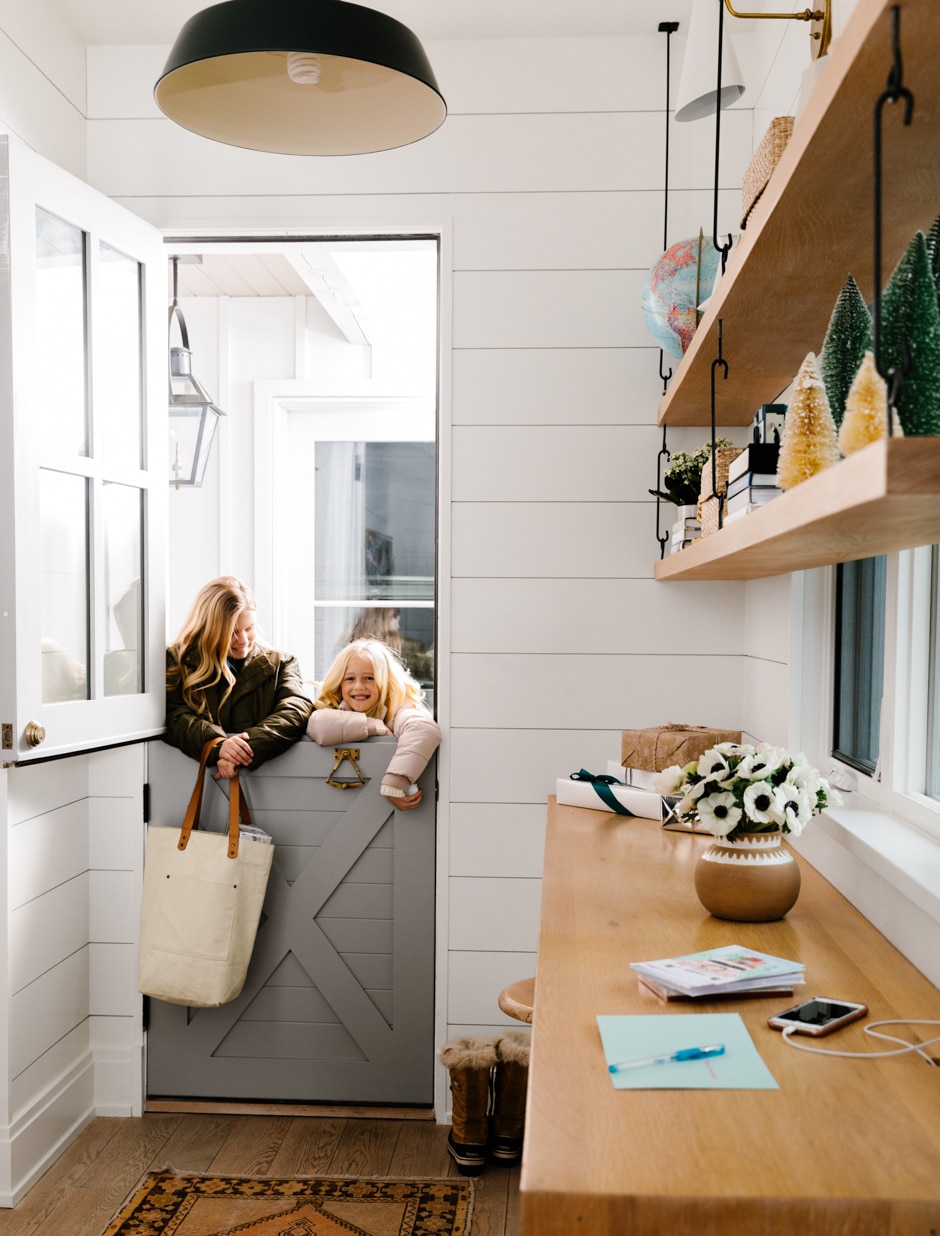 girls looking through split kitchen door