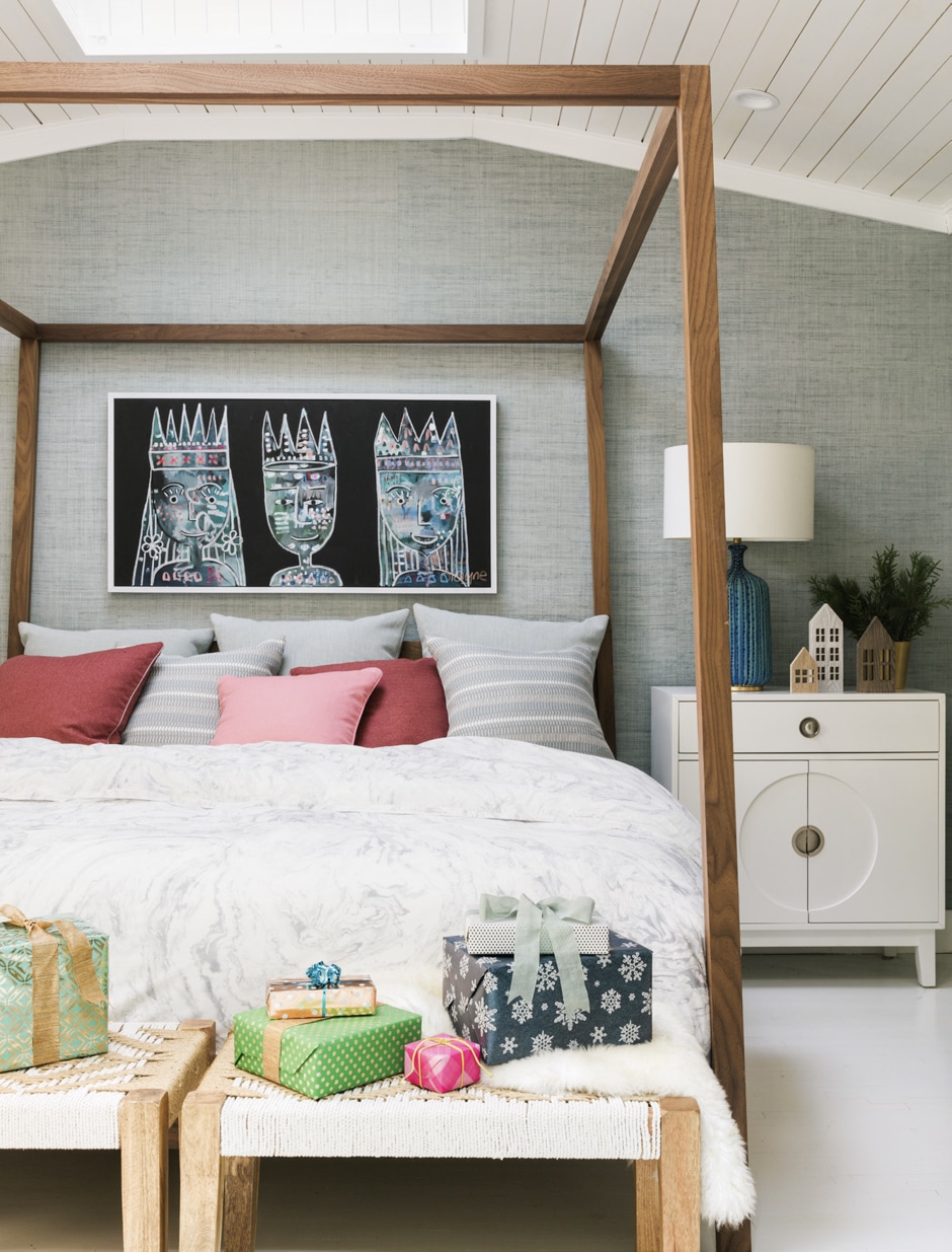 main bedroom with gray walls, pink accents, and presents on benches