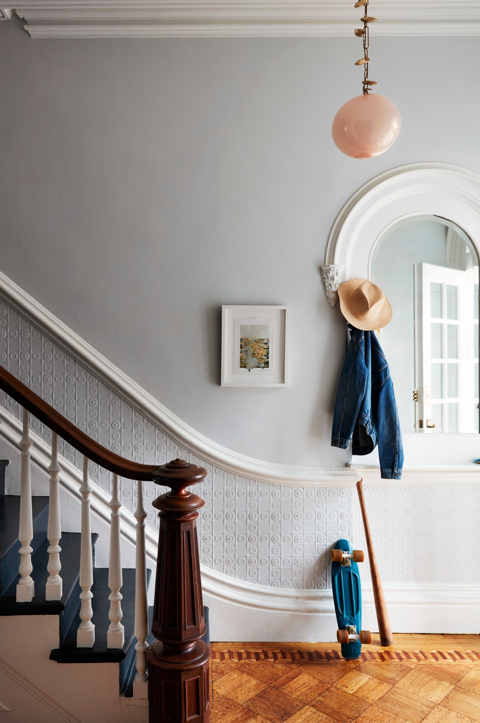 wooden staircase with white trim on gray wall