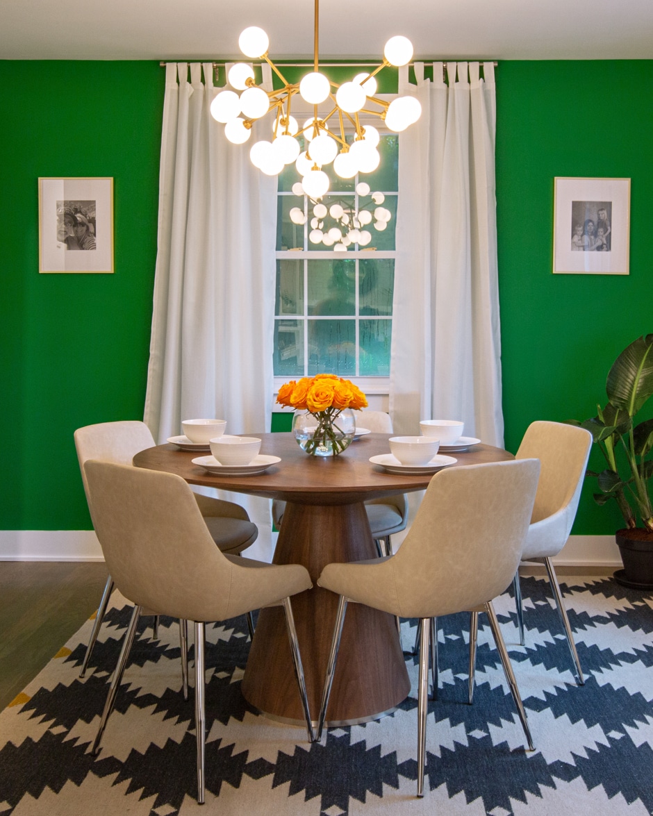 green dining room with patterned rug