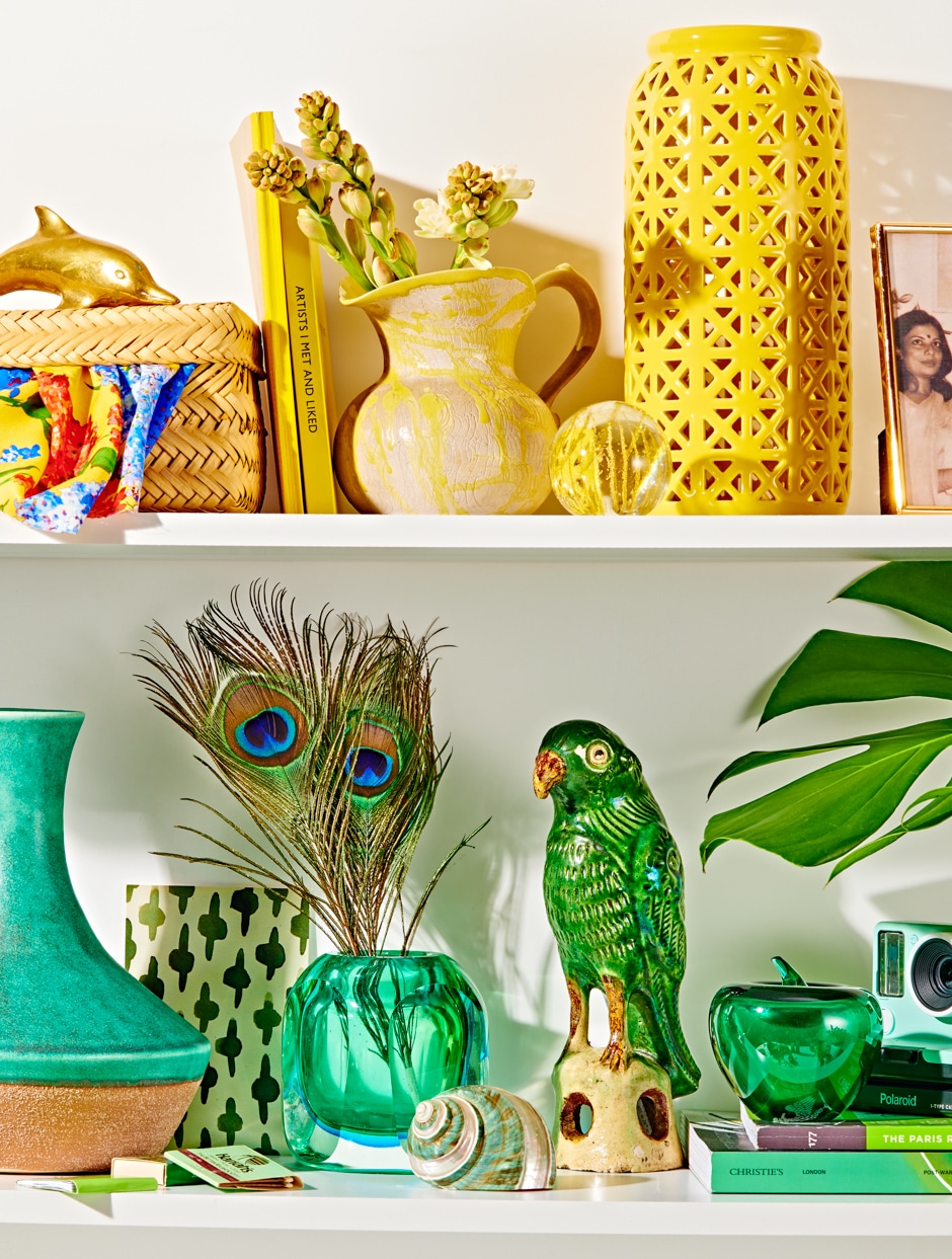 two white shelves of yellow and green colorful knickknacks