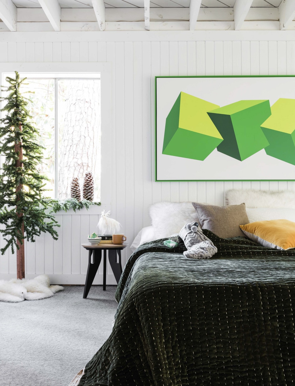 guest bedroom with white walls and green design accents