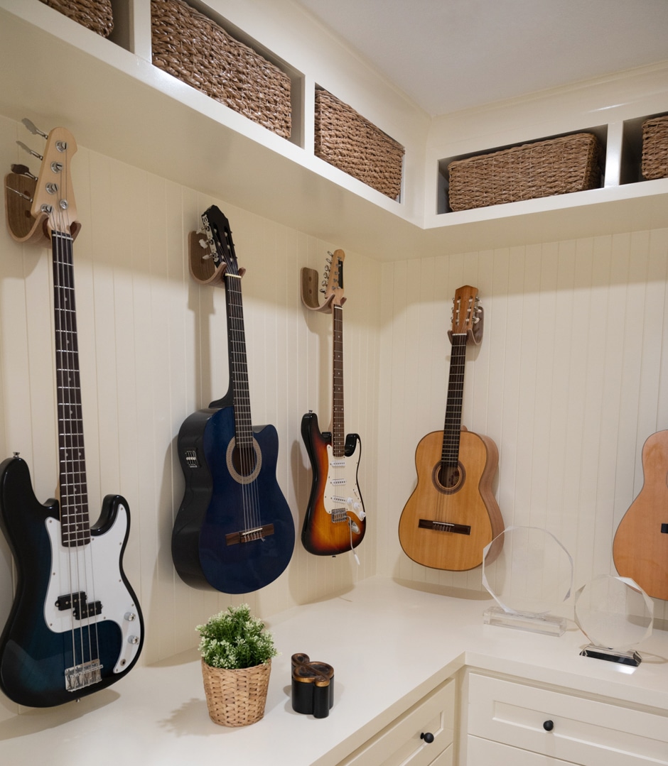 guitars hanging in white custom built cabinets
