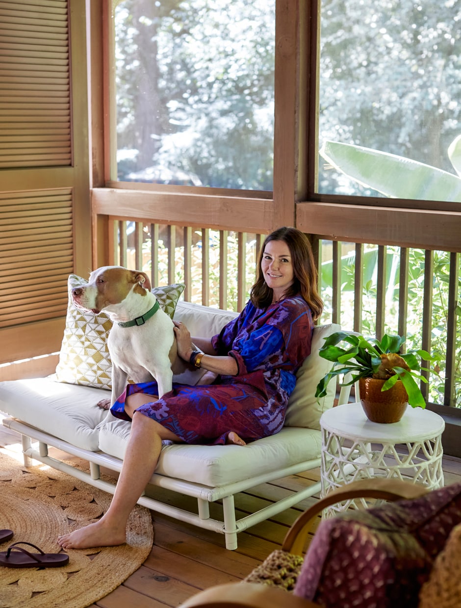 Jayme and dog sitting on screened-in porch