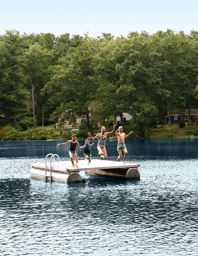 kids jumping off dock into lake