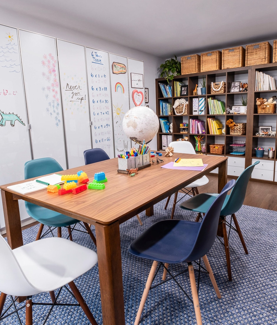 kids study area with white boards and wall shelves