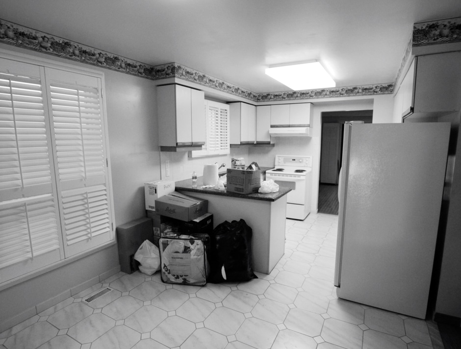 black and white photo of kitchen before remodel