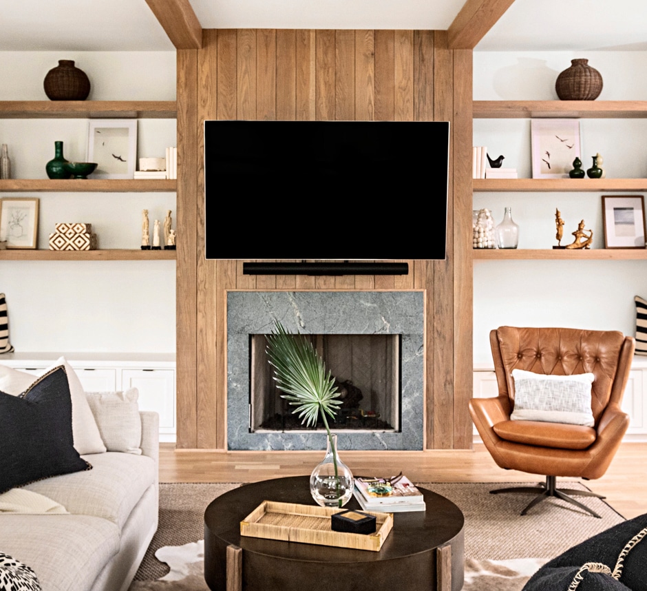 living room in neutral tones with plank wall behind TV