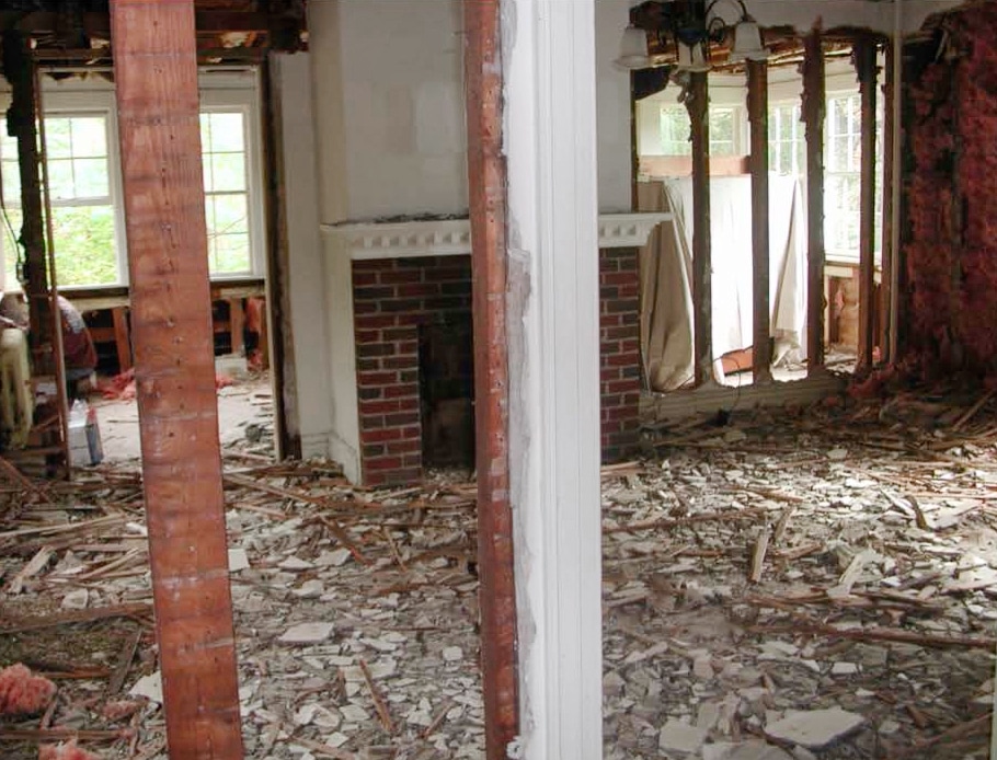 demolished living room with brick fireplace