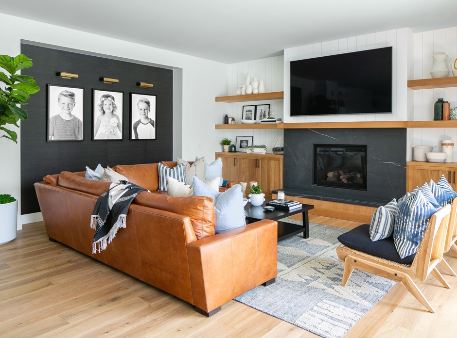 black, white, blue and tan living room with leather couch