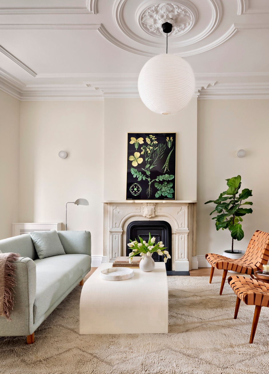 living room with plant artwork and cream colored trim