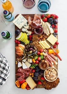 colorful appetizer platter on wooden cheeseboard
