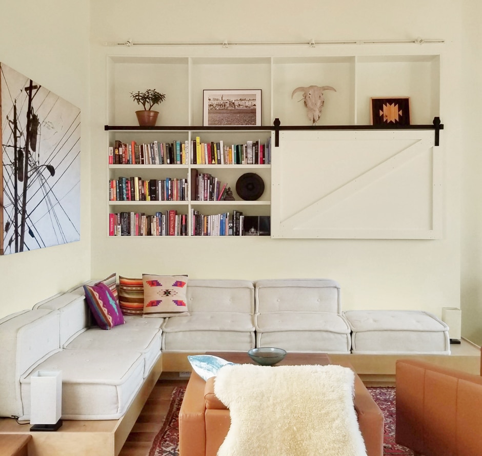 white and brown modern living room with bookshelves