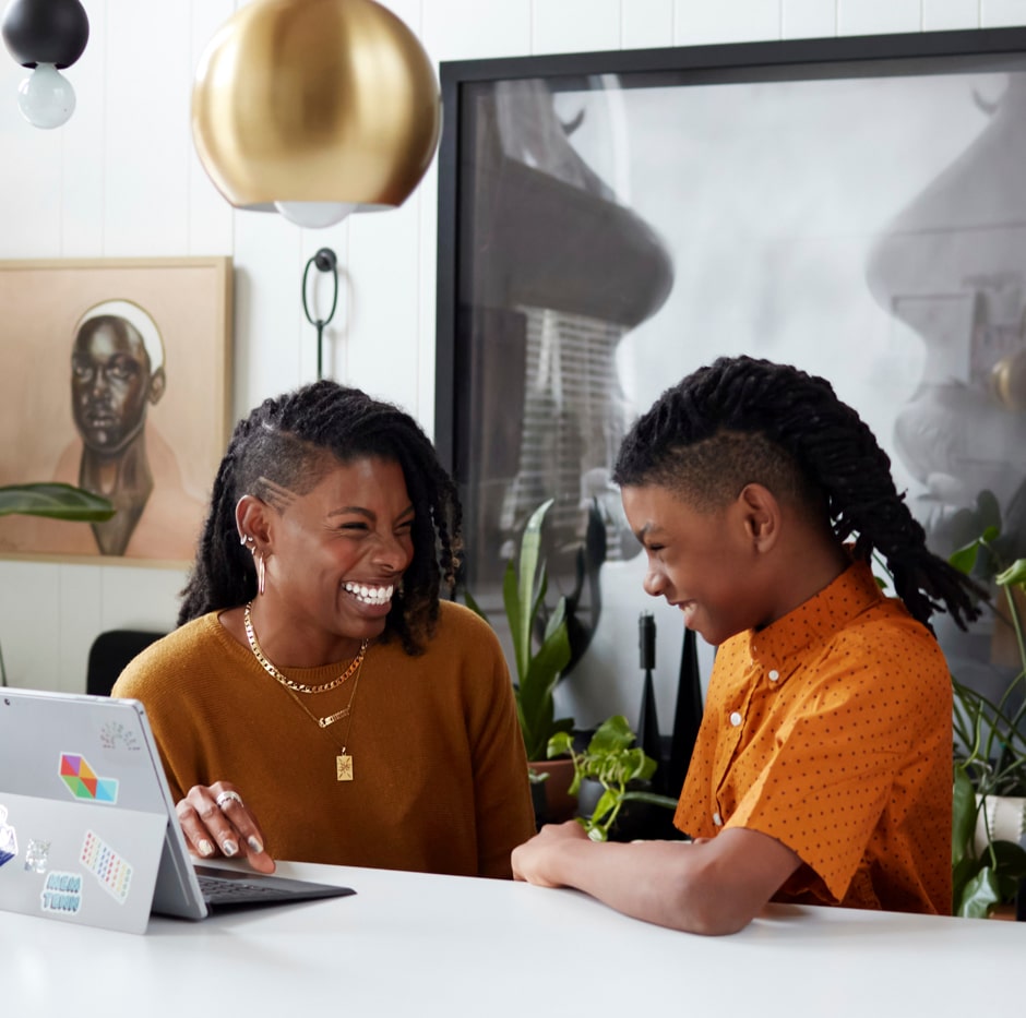 mother and son laughing during school at family countertop