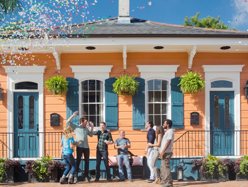 brothers and other people celebrating colorful new orleans home renovation