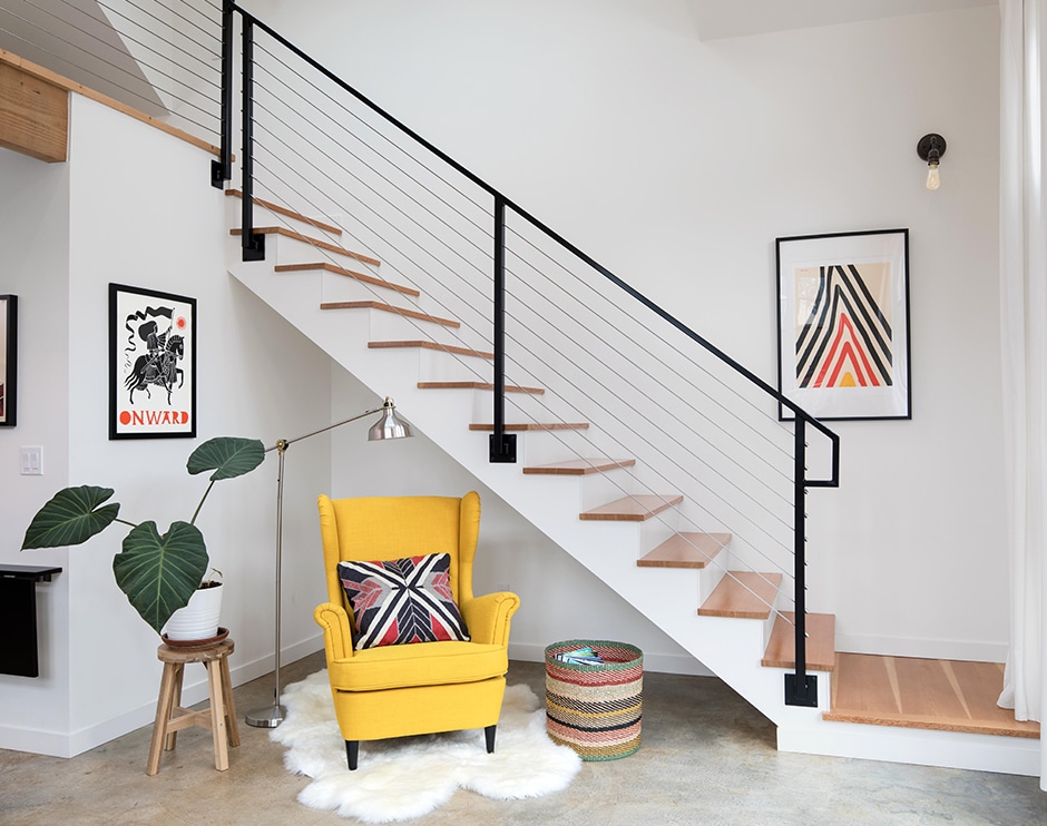 white modern stairway with yellow chair sitting area