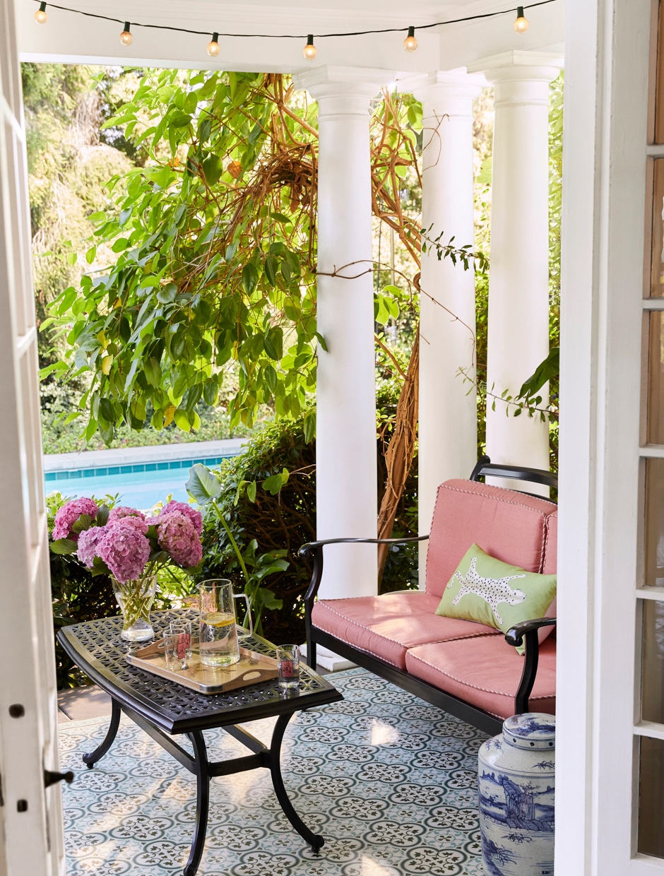 open french doors to porch with table and small couch