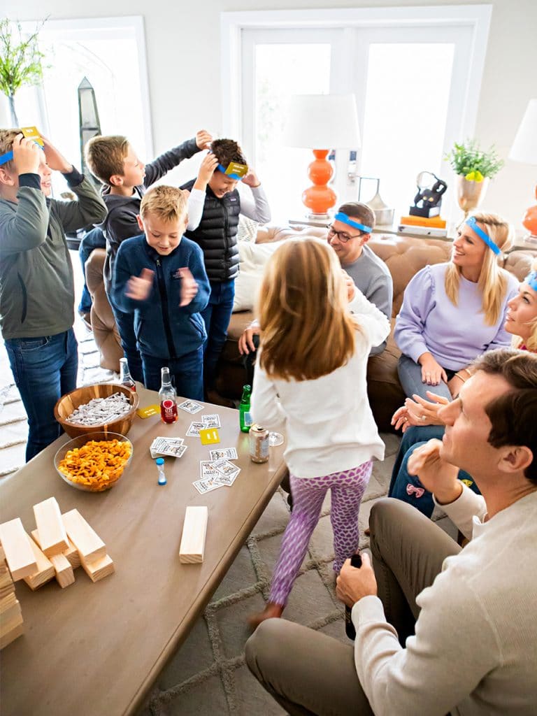 kids and adults playing lively games in living room