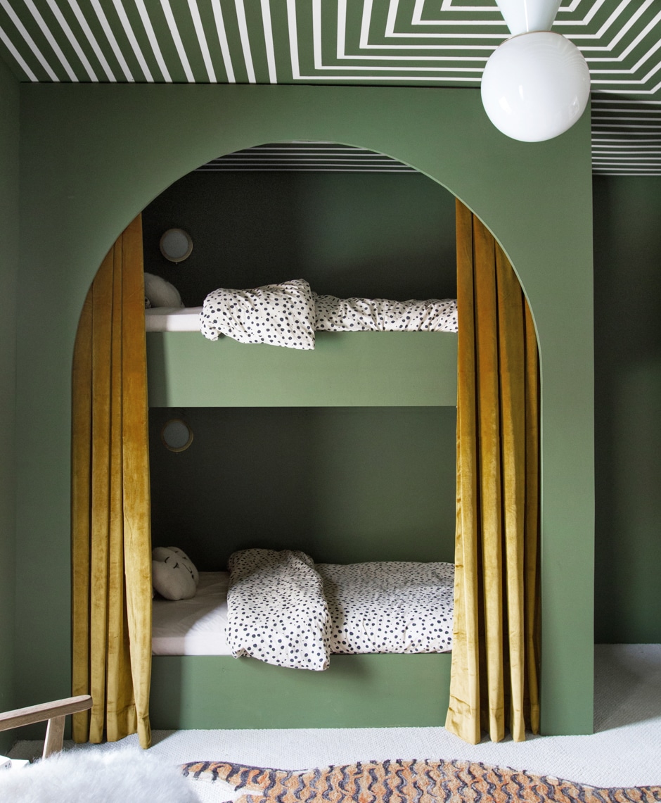 arched green wall with bunk beds