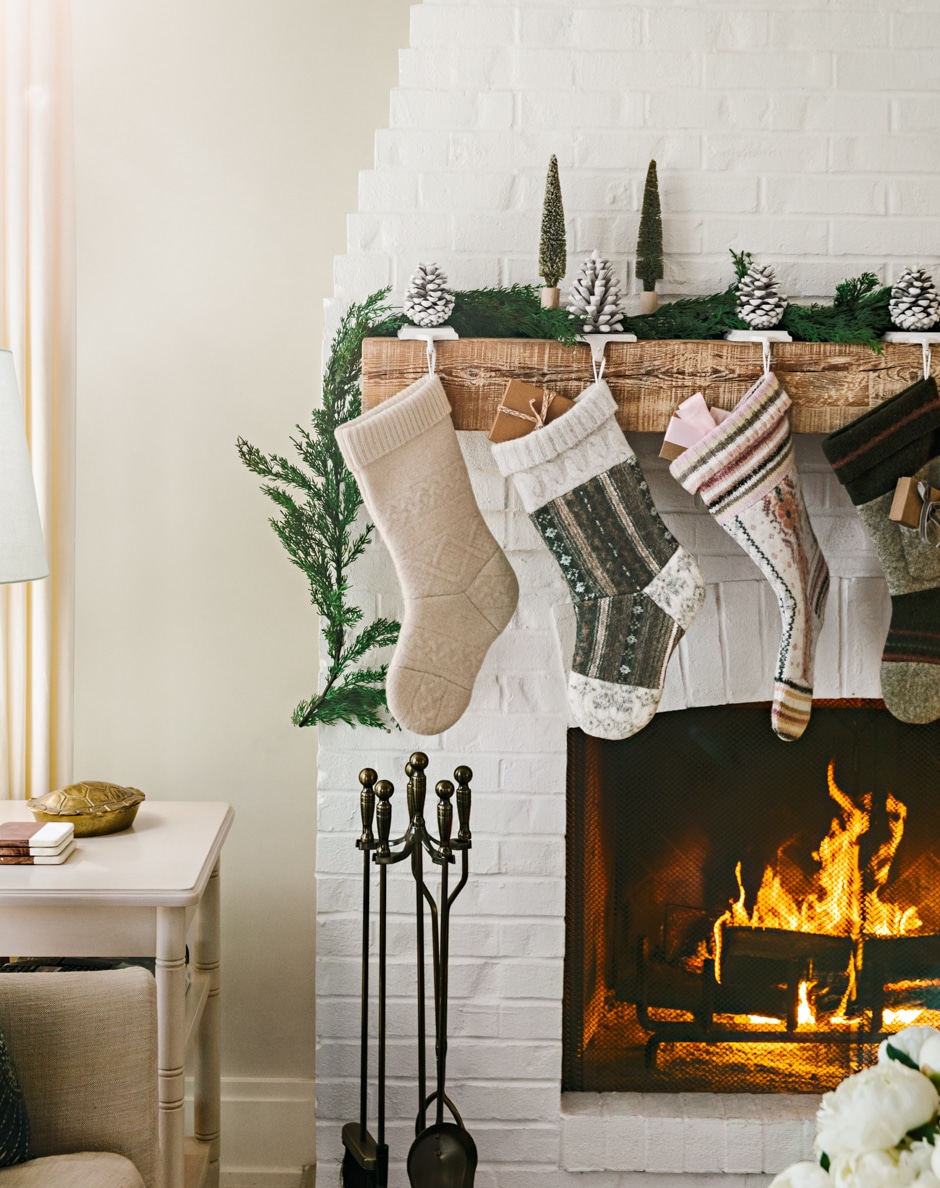 neutral tones patterned stockings hanging above fireplace