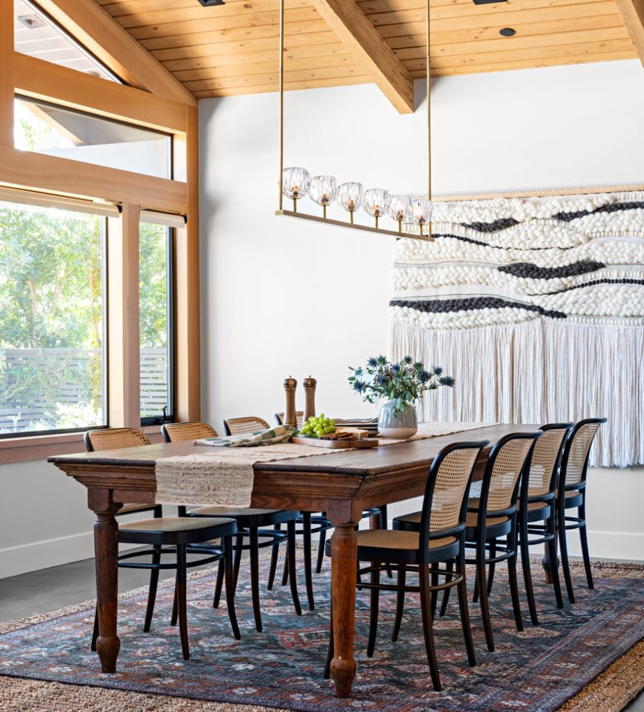 dining room with vaulted ceiling and traditional patterned rug