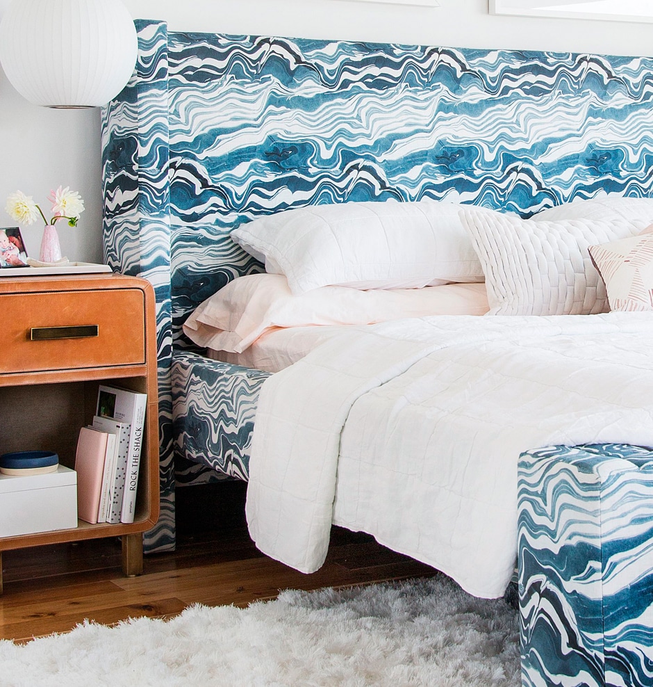 white bedroom with blue patterned headboard