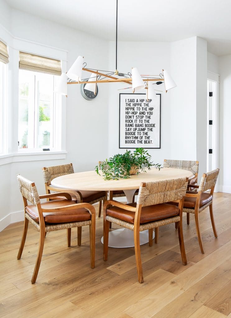 round wooden table in white dining area