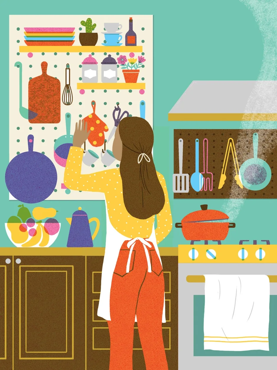 woman in kitchen with peg walls hanging items